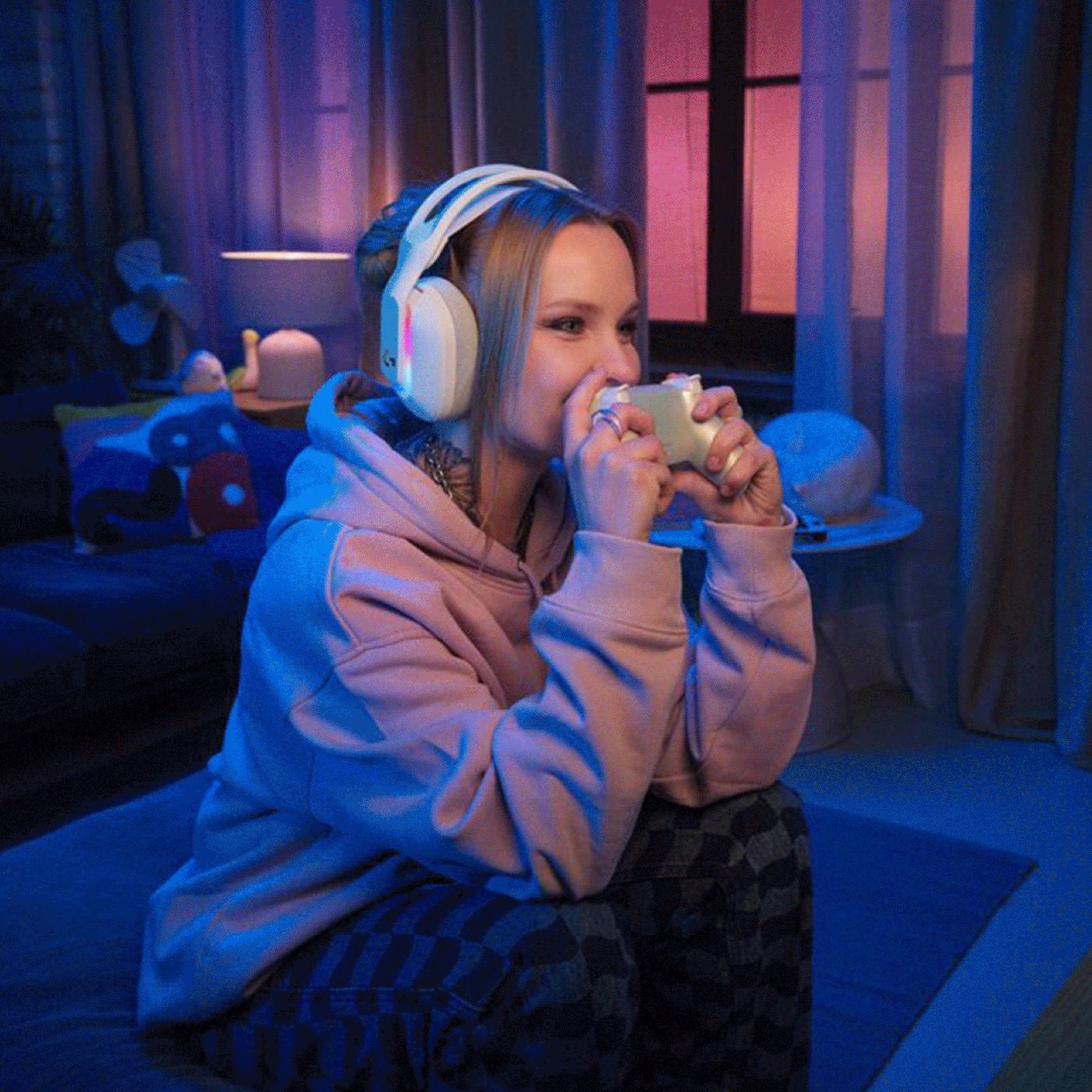 Person wearing headphones holding a controller